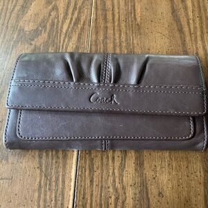 Coach Brown leather pleaded trifold wallet/clutch. Snap closure.